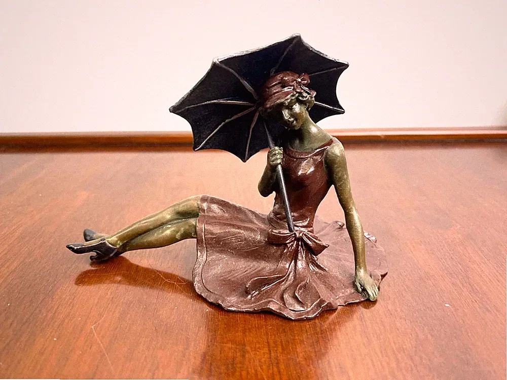 Bronze Sculpture of a reclining lady with umbrella after Franz Bergman